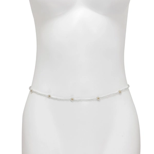 Detail view of Bohemian white seed bead waist chain with gold accents on mannequin