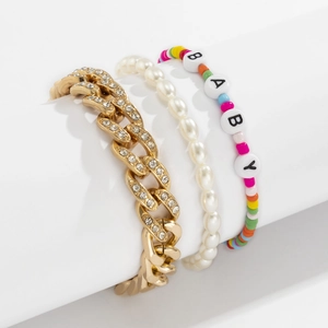 Detailed view of 3pcs set featuring iced out cuban chain, pearls and BABY beaded bracelet