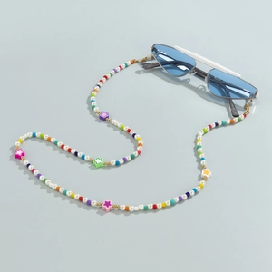 Detail of colorful beads and star charms on a versatile pearl eyewear chain