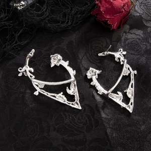 Close-up of gothic silver rose earrings with intricate thorn and leaf engraving details
