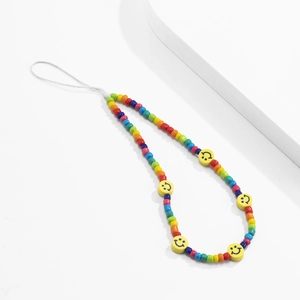 Detail of colorful rainbow beads phone strap with yellow smiley face charms and white cord