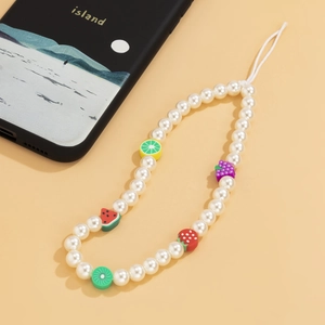 Detail of colorful fruit charms and white pearls on a summer style phone strap