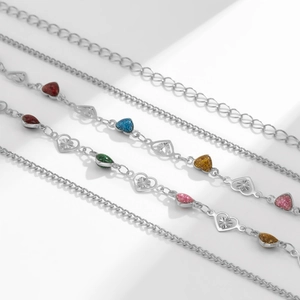 Detailed macro view of colorful enamel heart pendants on a silver metal waist chain