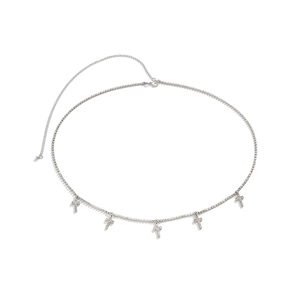 Macro detail of silver body chain featuring sparkling rhinestone cross pendants and lobster clasp
