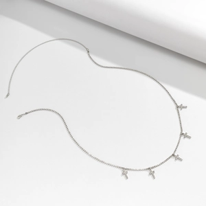 Detail view of silver body chain with five rhinestone cross pendants and lobster clasp closure