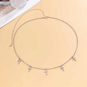 Detailed view of sparkling rhinestone waist chain with five dangling crystal cross charms