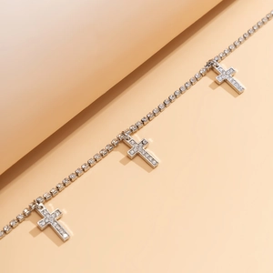 Detail of silver body chain with rhinestone-encrusted crosses and fine metal links