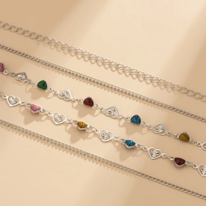 Silver body chain featuring multi-colored heart pendants and hollow metal links