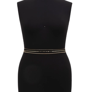 Detailed layered golden body chain set with sequins and beads on a black mannequin