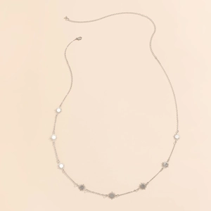 Hip hop silver chain body belt with star pendants on a minimalist beige background