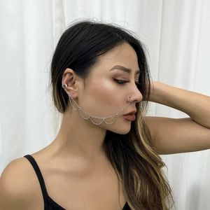 Silver punk style nose-to-ear chain with faux pearls and butterfly charms on a model