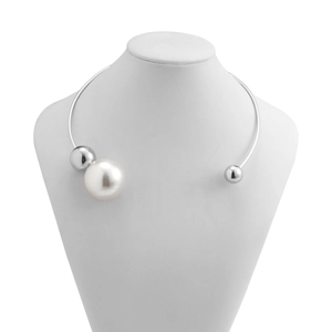 Detail of silver geometric choker collar with a white pearl and metallic bead accents