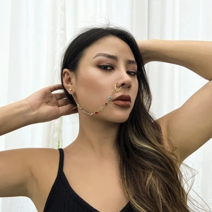 Detailed view of bohemian gold nose ring chain with colorful gemstones and butterfly accents