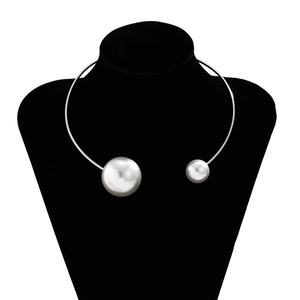 Detail of a silver minimalist metal choker with asymmetrical faux pearls on a neck model