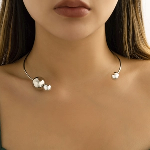 Minimalist silver choker with polished metal spheres and asymmetrical open ring design