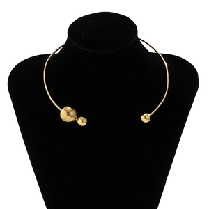 Detail of a minimalist gold metal asymmetric choker with polished beads on a neck display