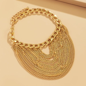 Close-up of gold chunky curb chain with layered tassel fringe detail and metallic sheen