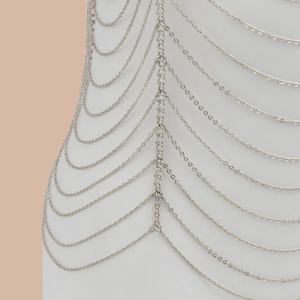 Multilayered silver body chain with geometric hollow design on a mannequin