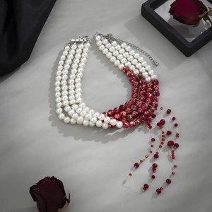 Macro shot of 5-layer pearl choker with red marble beads and blood drop tassel design