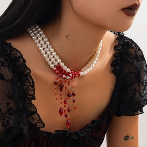 Detailed view of gothic three-layer pearl choker with red blood droplet bead fringe