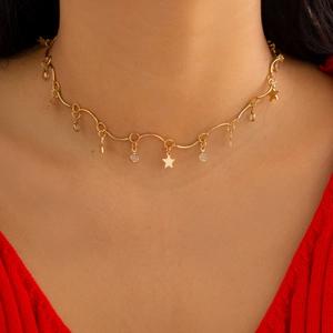 Star tassel gold choker necklace with crystal charms worn on a woman's neck