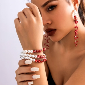 Detail of Gothic pearl and red bead wrap bracelet with matching long tassel earrings