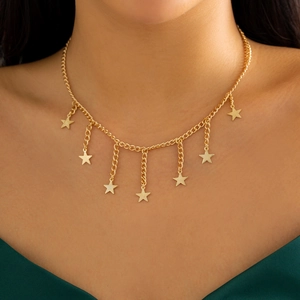 Close-up of golden star tassel necklace on model's neck for elegant party style
