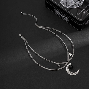 Dettaglio della collana a strati in argento con luna traforata e pendenti a stella