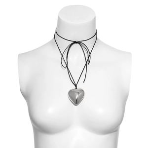 Detailed view of large silver heart pendant with adjustable black ribbon choker tie