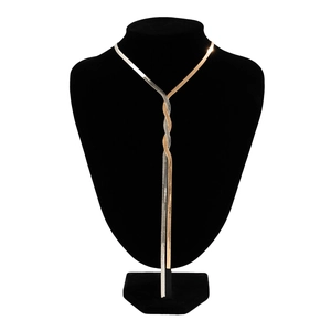Detail view of intertwined gold and silver snake chain necklace on a black bust display