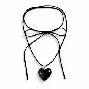 Detail view of the adjustable long velvet cord choker with a large black heart pendant