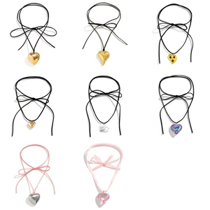 Exaggerated heart pendant necklaces with metallic and resin finishes on velvet cords