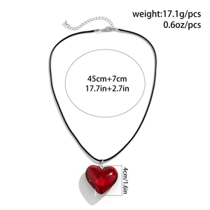 Detailed view of a 4cm red 3D heart pendant with black cord and silver clasp