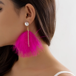 Elegant fuchsia feather tassel earrings with crystal studs shown on model profile