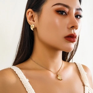 Close-up of elegant gold starfish necklace and earrings set worn by a model