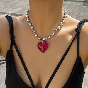 Y2K style necklace with large translucent red heart pendant and silver bead chain