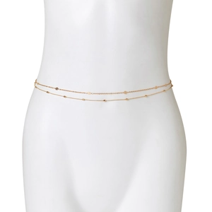 Detailed view of a golden double-layered body chain featuring delicate five-petal flowers