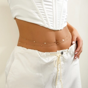 Detail of double-layer gold chain waist link with smiley face pendant and beads