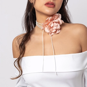 Detailed view of the large pink satin flower choker necklace with long tassel ties