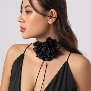 Detailed view of the large black satin fabric flower choker with adjustable lace-up ties