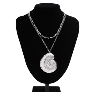 Silver double-layer necklace with large nautilus shell pendant on black neck display