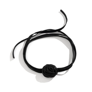 Detailed macro view of a 3D black fabric rose choker necklace with elegant long ribbon ties