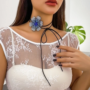 Bloemen choker ketting met blauwe kristallen op zwart waskoord en franjes accenten