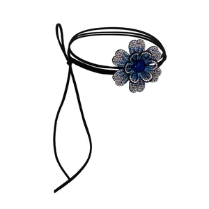 Detail van bloem choker met schitterende blauwe kristallen en zwarte waxkoorden sieraad