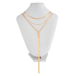 Detail view of triple-layered gold snake bone chain necklace with vertical Y-shaped fringe