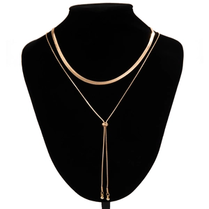Detail of gold double-layered necklace with herringbone chain and adjustable sliding bead