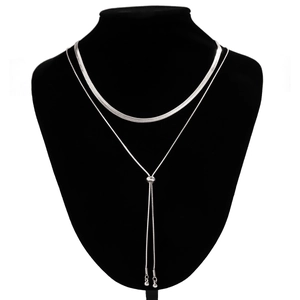 Detail of a layered silver snake chain and adjustable beaded slide clasp on neck model
