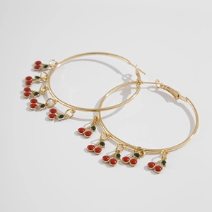 Detail view of large gold hoop earrings featuring multiple red cherry leaf charms