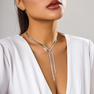 Elegant silver snake chain necklace with Y-shaped tassel design worn on a model