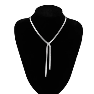 Detailed view of silver herringbone Y-necklace with polished metallic geometric pendant